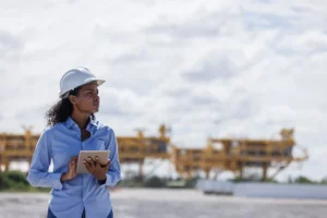 Female engineer digitizing field operations using tablet for mining site inspections and data collection